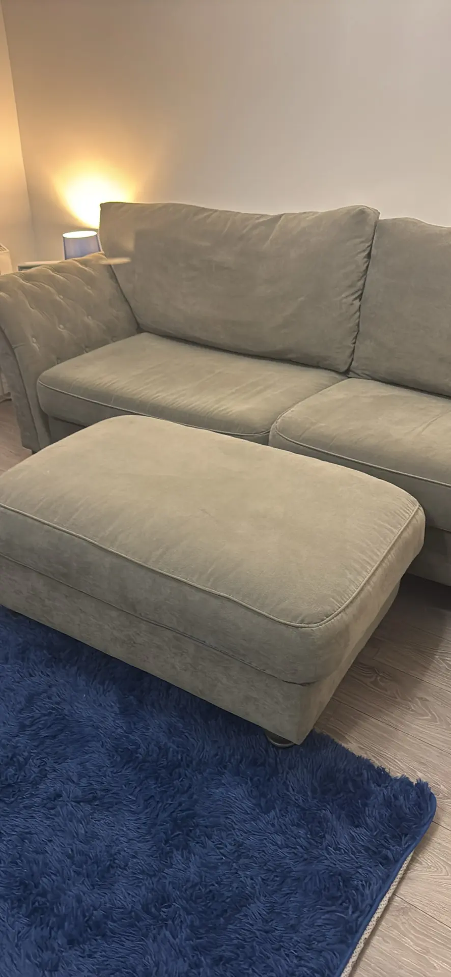 Large grey 4 seater tufted sofa and foot stool
