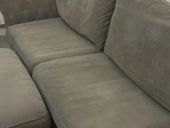 Large grey 4 seater tufted sofa and foot stool