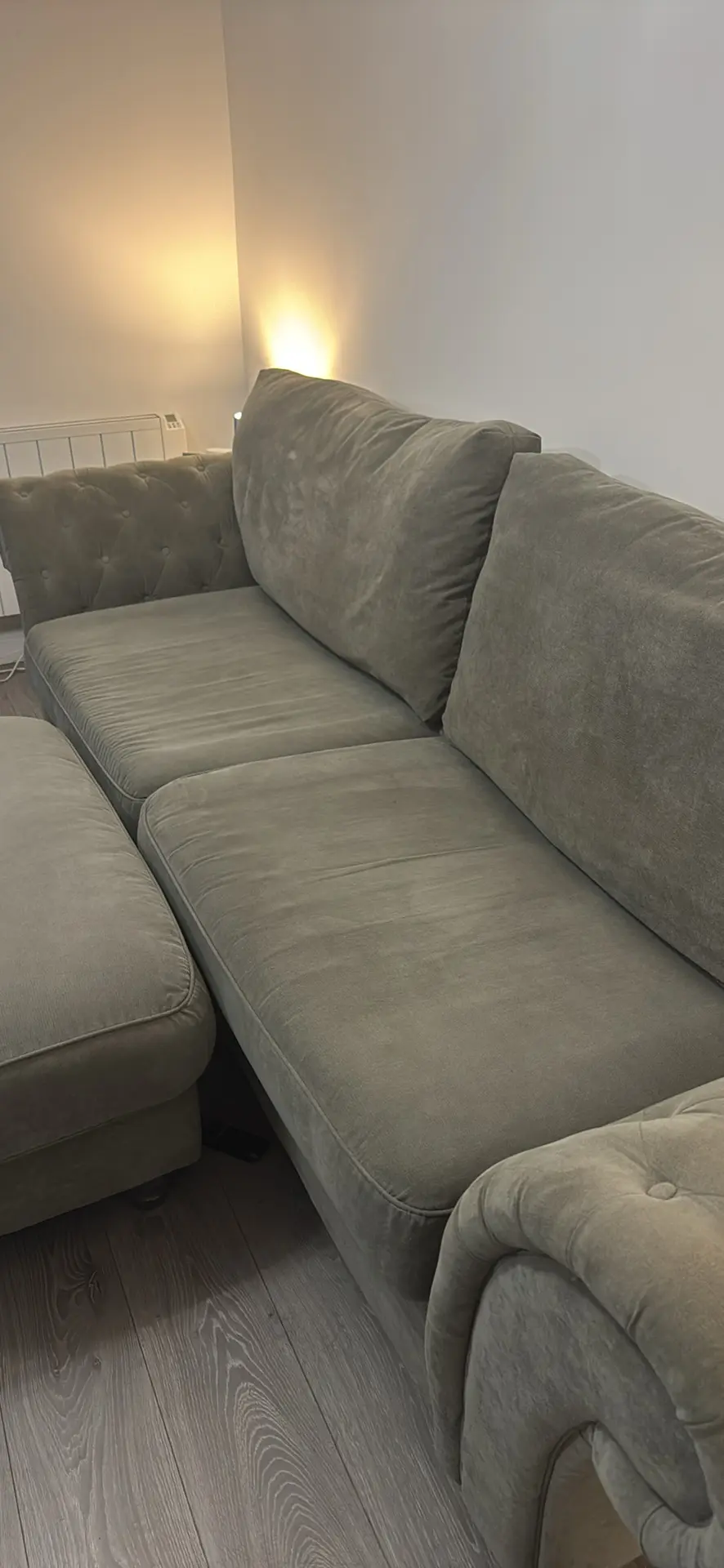Large grey 4 seater tufted sofa and foot stool