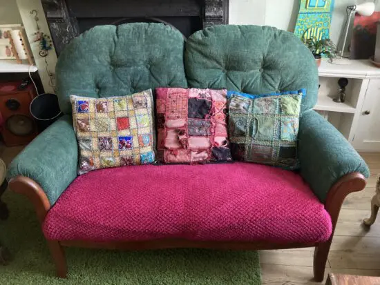 Small two seat green sofa