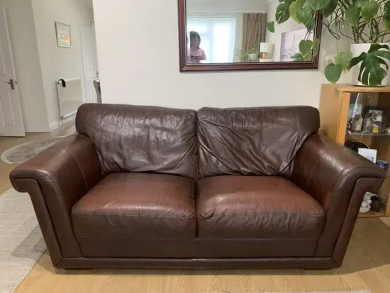 M&S 2 x briwn leather 3 seater sofas and matching storage footstool