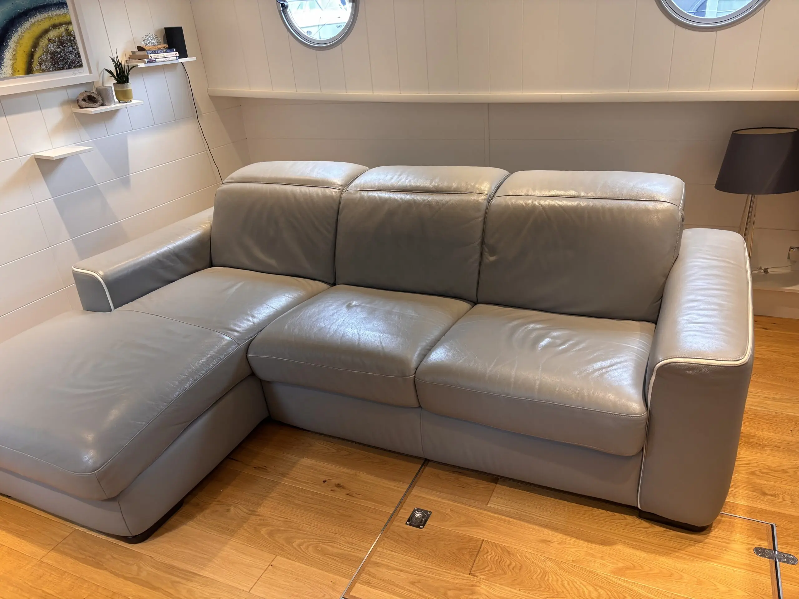 Grey leather Natuzzi 4 seater corner sofa bed, with storage chaise.