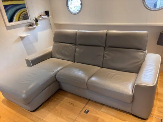 Grey leather Natuzzi 4 seater corner sofa bed, with storage chaise.