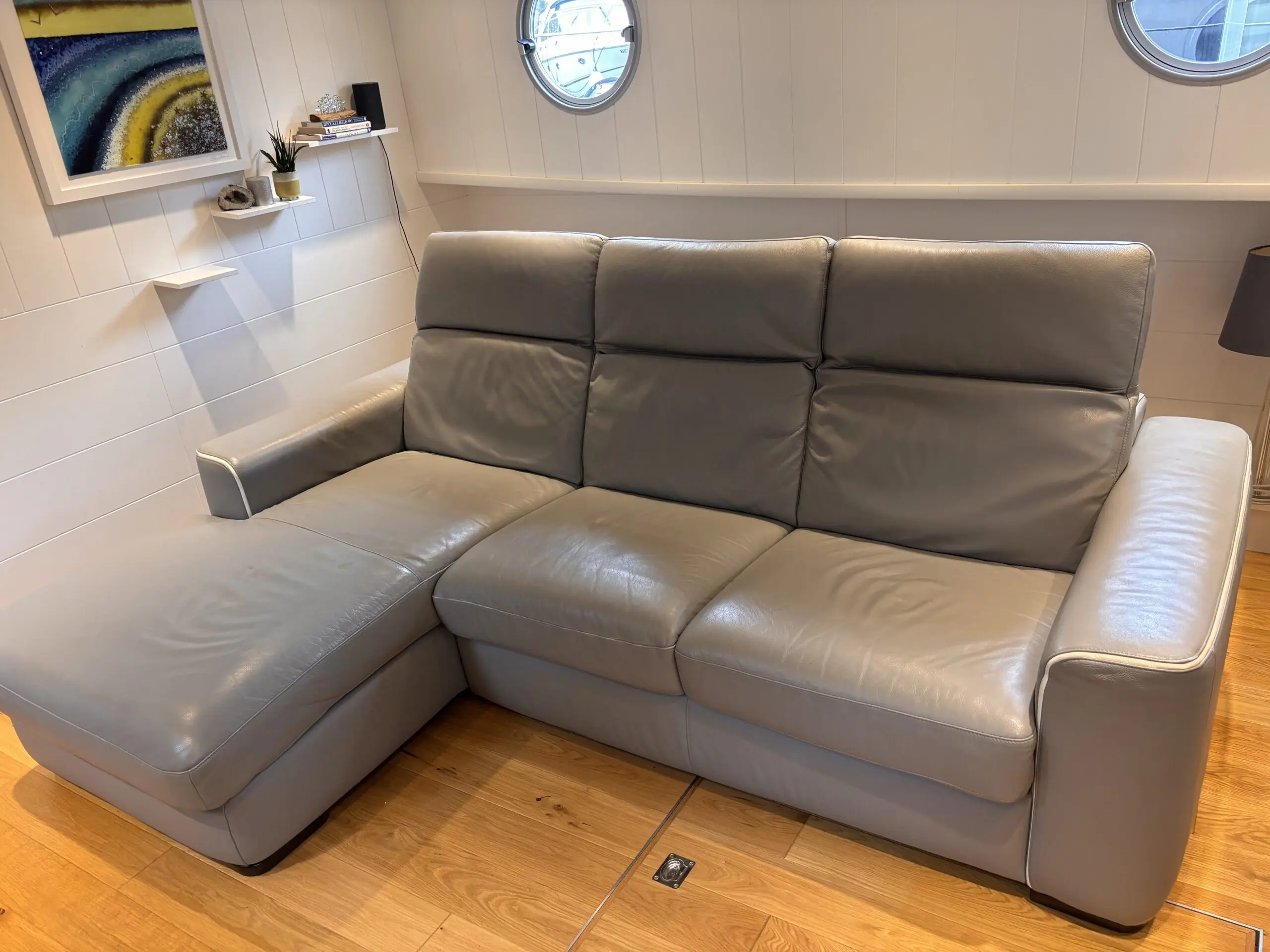 Grey leather Natuzzi 4 seater corner sofa bed, with storage chaise.