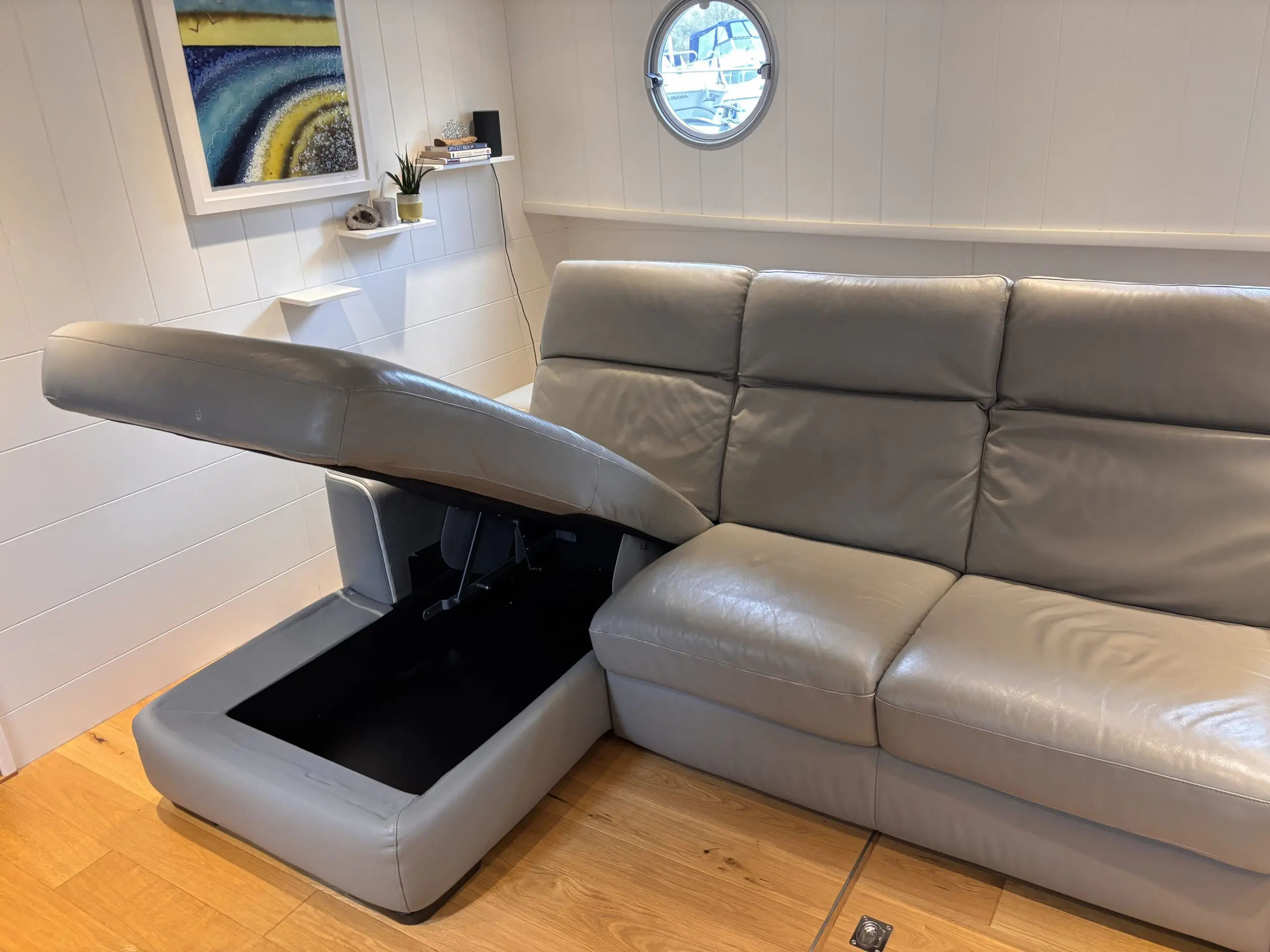 Grey leather Natuzzi 4 seater corner sofa bed, with storage chaise.