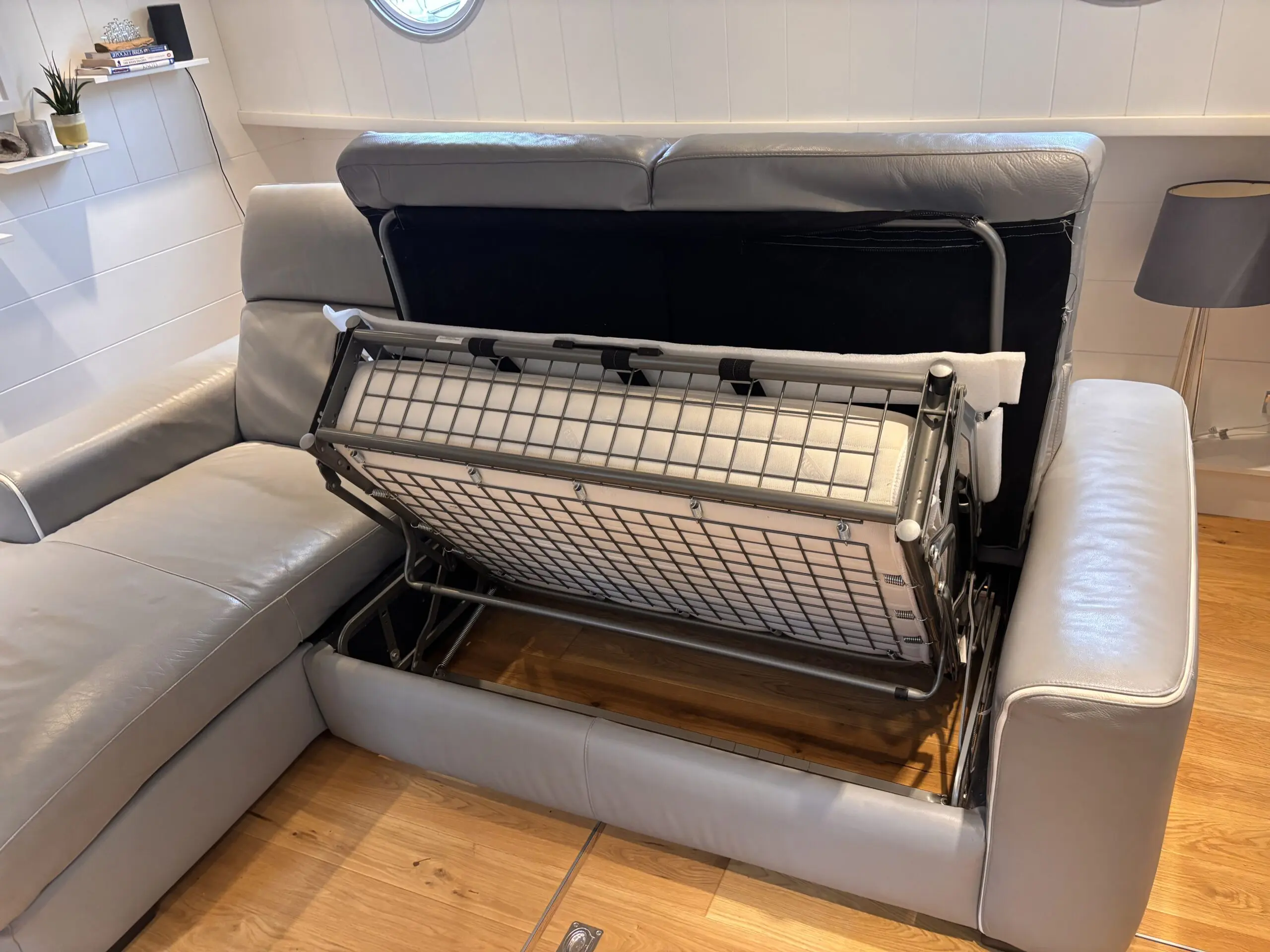 Grey leather Natuzzi 4 seater corner sofa bed, with storage chaise.