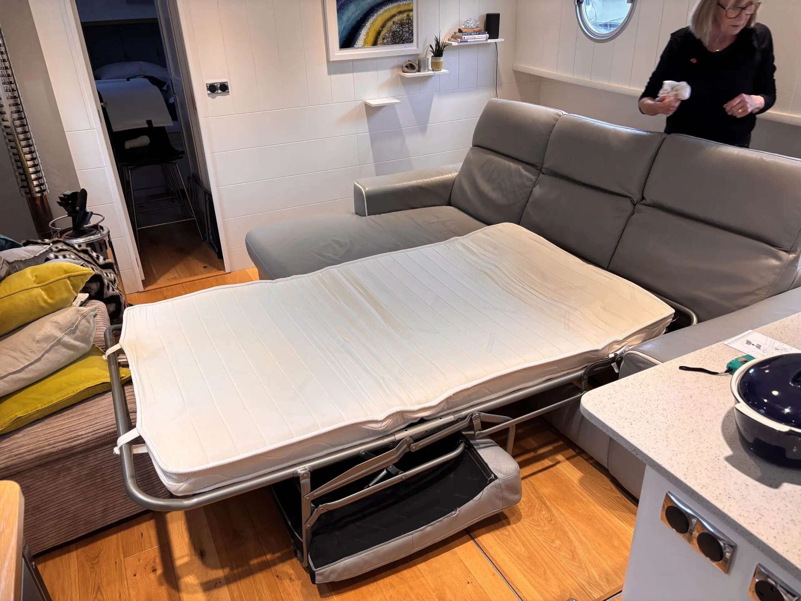 Grey leather Natuzzi 4 seater corner sofa bed, with storage chaise.