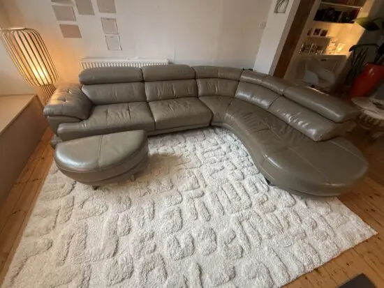 Taupe leather right hand corner sofa with footstool