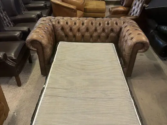 Chesterfield tan real leather two seater sofa bed