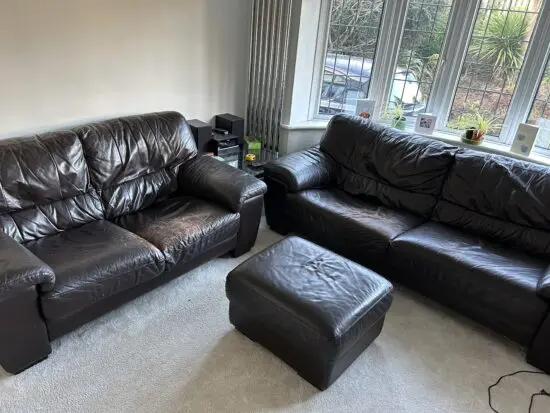 DFS black leather sofas and footstool