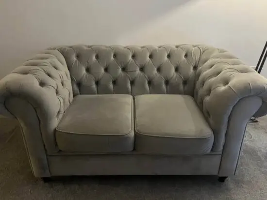Two seater grey chesterfield sofa