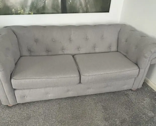 Chesterfield style sofa with footstool storage