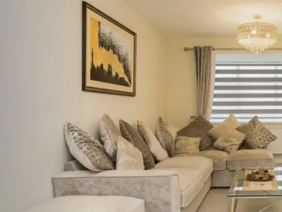 L shaped sofa with a side stool and a matching arm chair