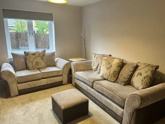 Beige and brown cord sofa with scatter back