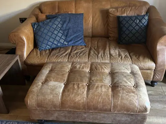 2 distressed leather sofas and footstool