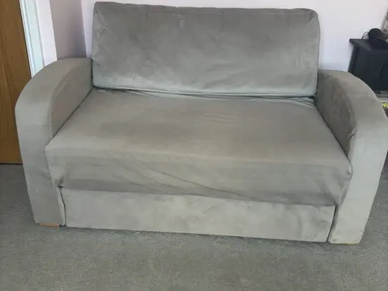 Grey velvet two seater sofa bed