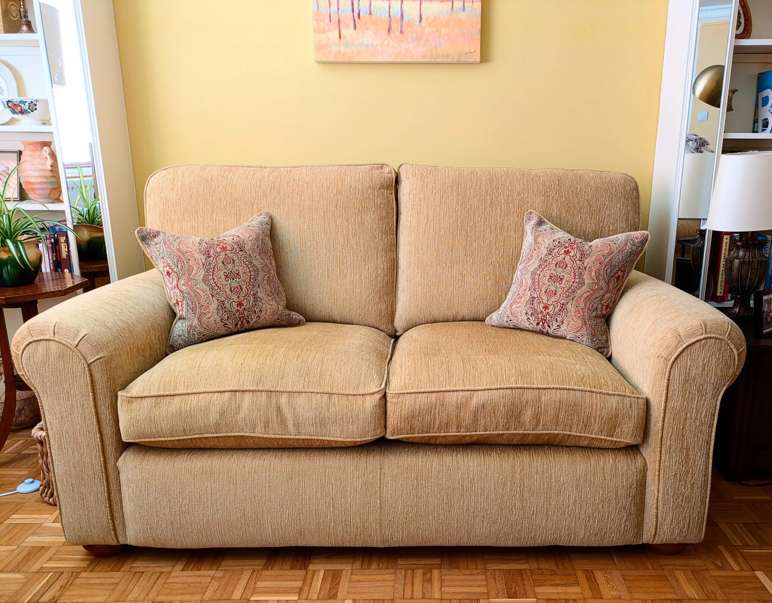 Two identical Parker Knoll sofas in soft gold chenille fabric.