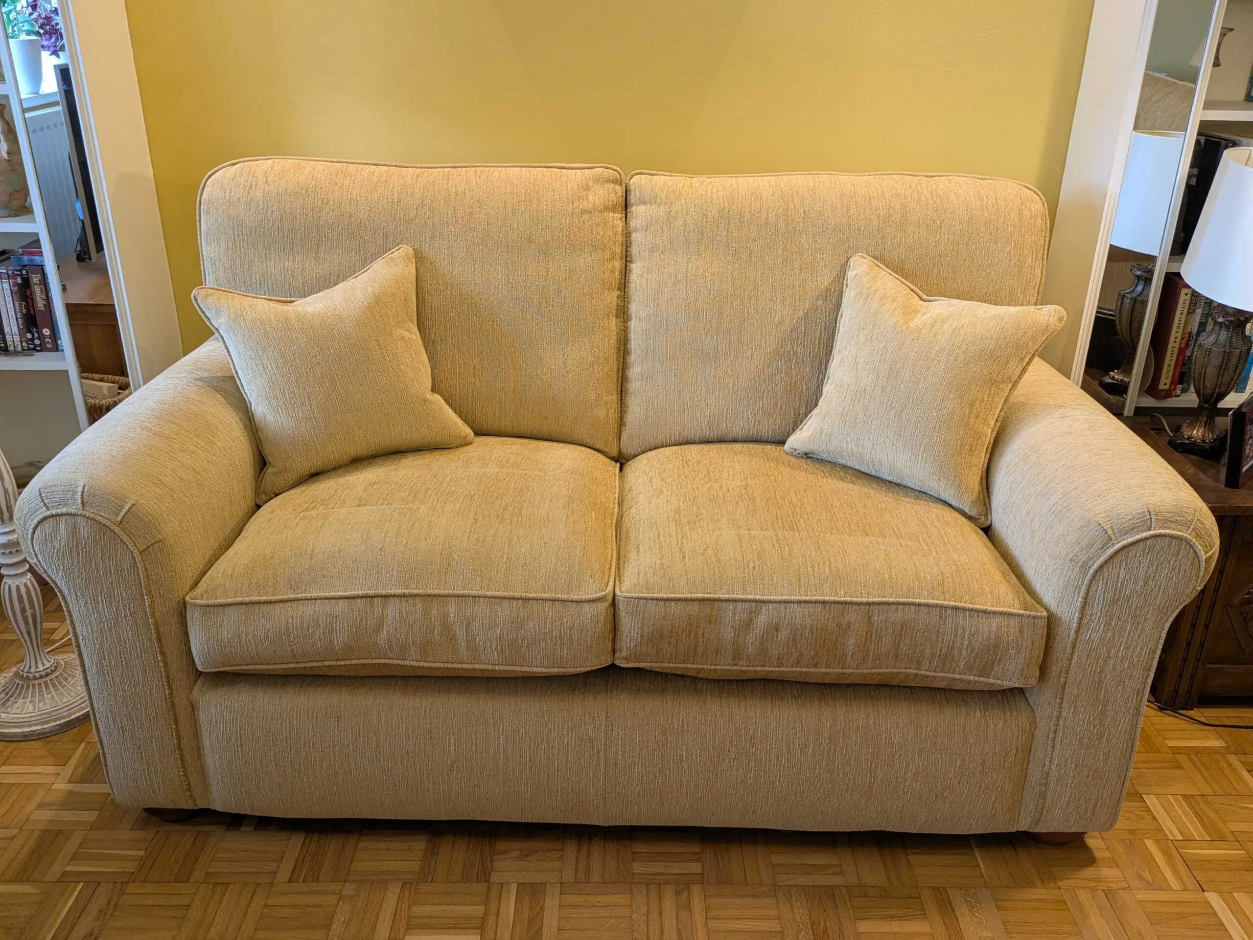 Two identical Parker Knoll sofas in soft gold chenille fabric.