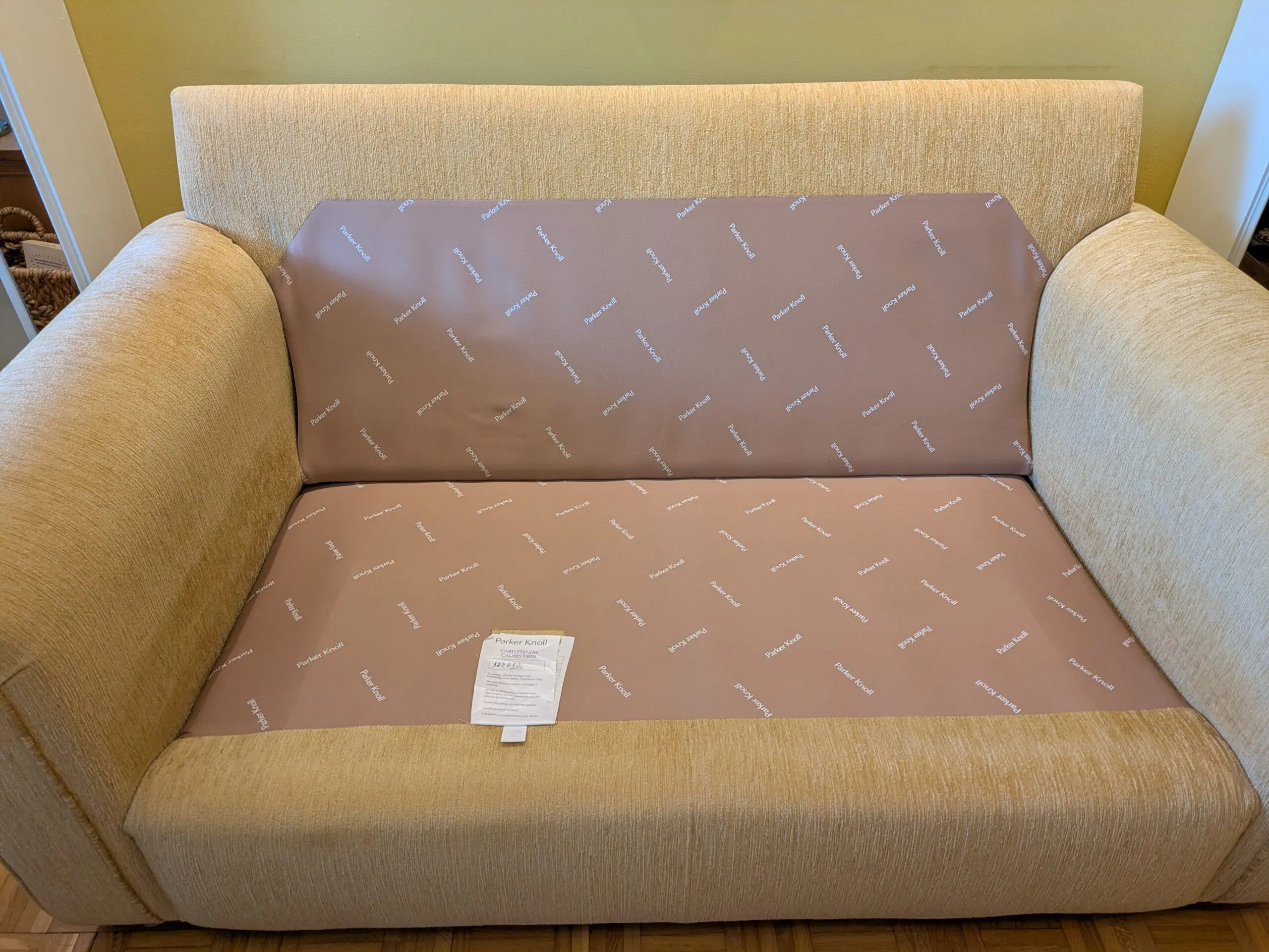 Two identical Parker Knoll sofas in soft gold chenille fabric.