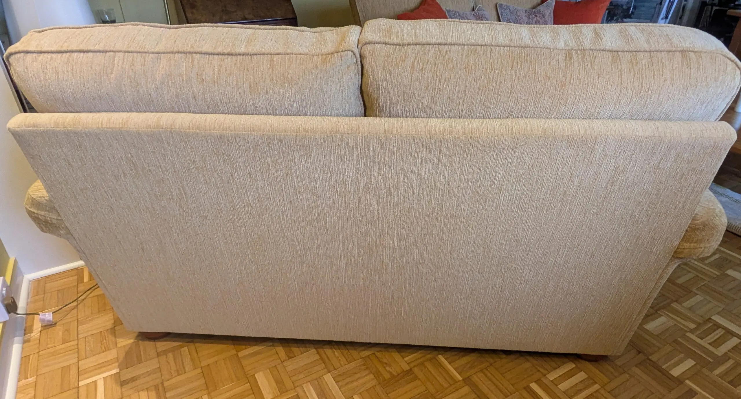Two identical Parker Knoll sofas in soft gold chenille fabric.