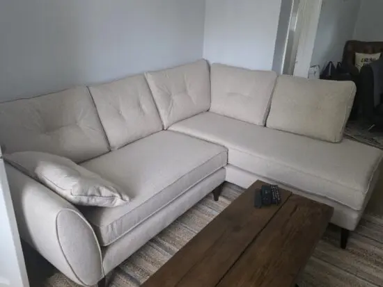 DFS Oatmeal/cream corner sofa and footstool