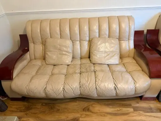 Cream leather sofa set, with brown wooden armrest . 3 seater sofa and 2 chairs