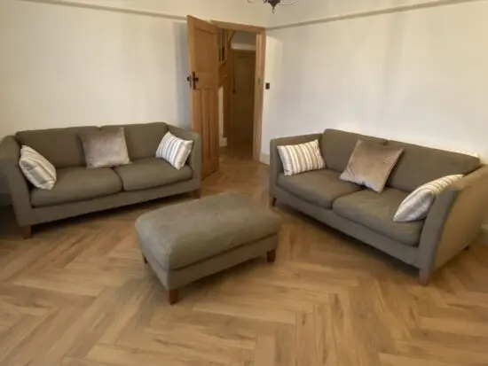 Two Large 2 Seater Sofas and Footstool By Nick Munro