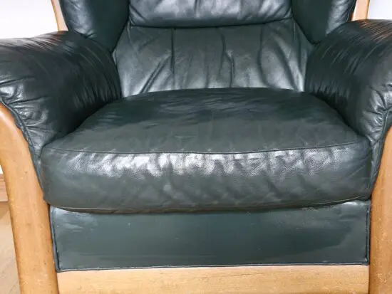 Ercol solid wood frame sofa and chair in green leather