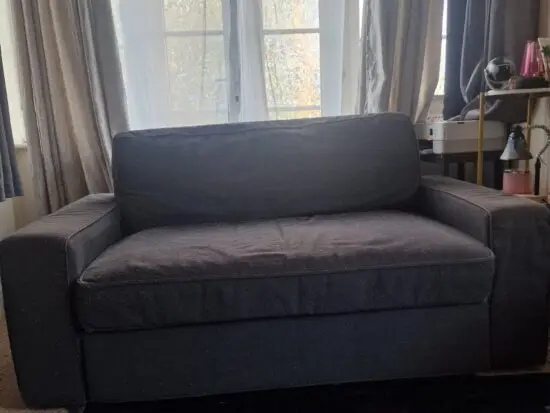 IKEA Vilasund sofa bed in a dark grey fabric cover.