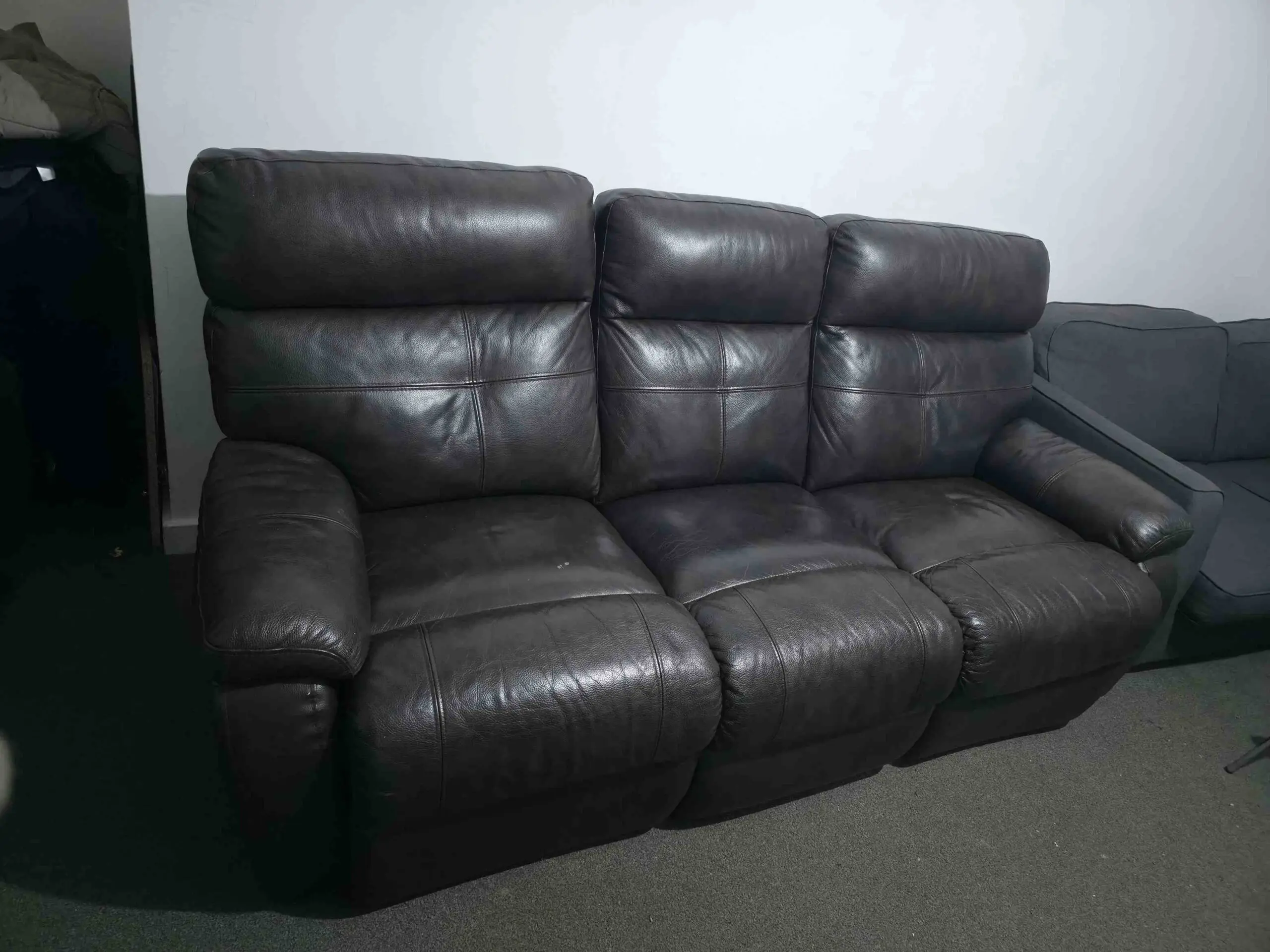 Dark brown 3 seater sofa with 2 seat having manual recliner.