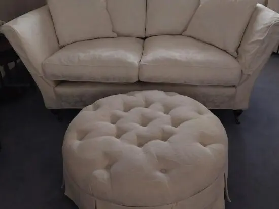 White 2 seat sofa with footstool
