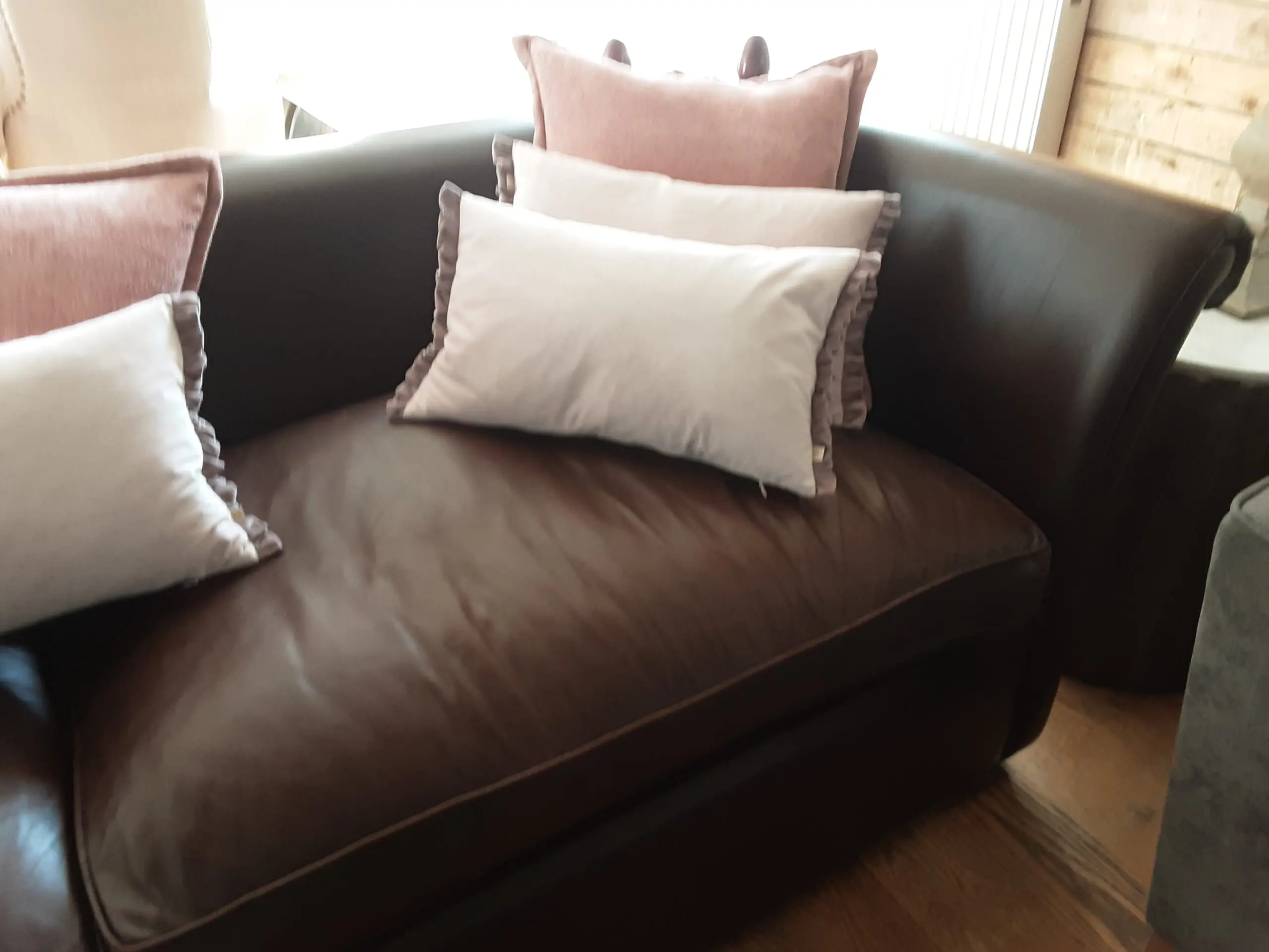 A PAIR OF LARGE LAURA ASHLEY LEATHER SOFAS in BROWN
