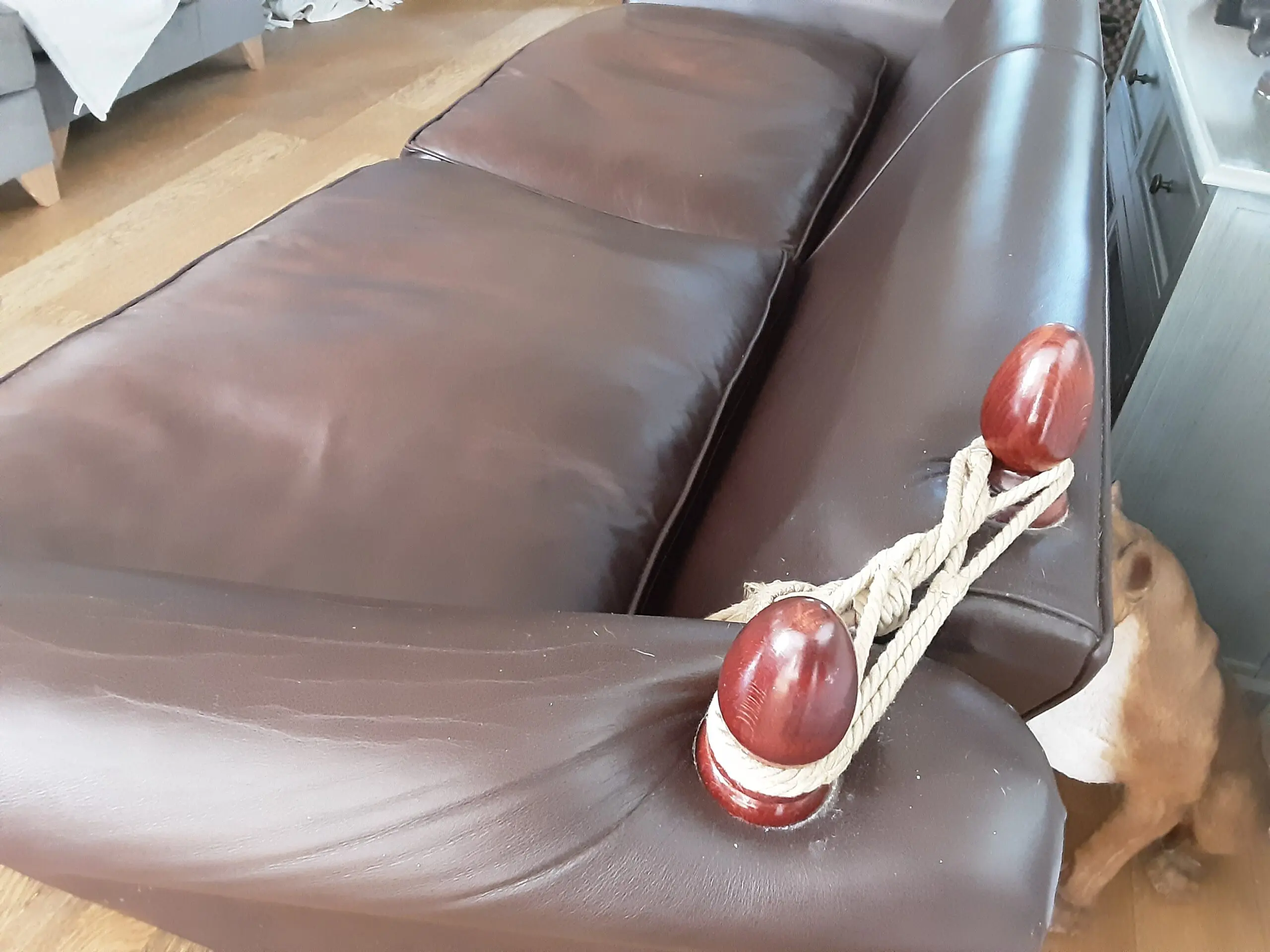 A PAIR OF LARGE LAURA ASHLEY LEATHER SOFAS in BROWN