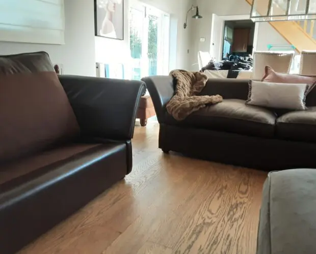 A PAIR OF LARGE LAURA ASHLEY LEATHER SOFAS in BROWN