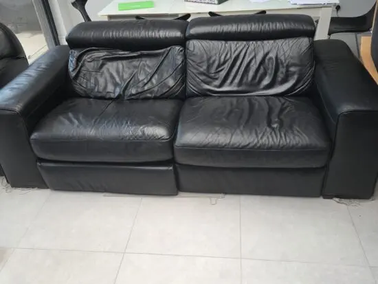 Black leather natuzzi reclining sofa