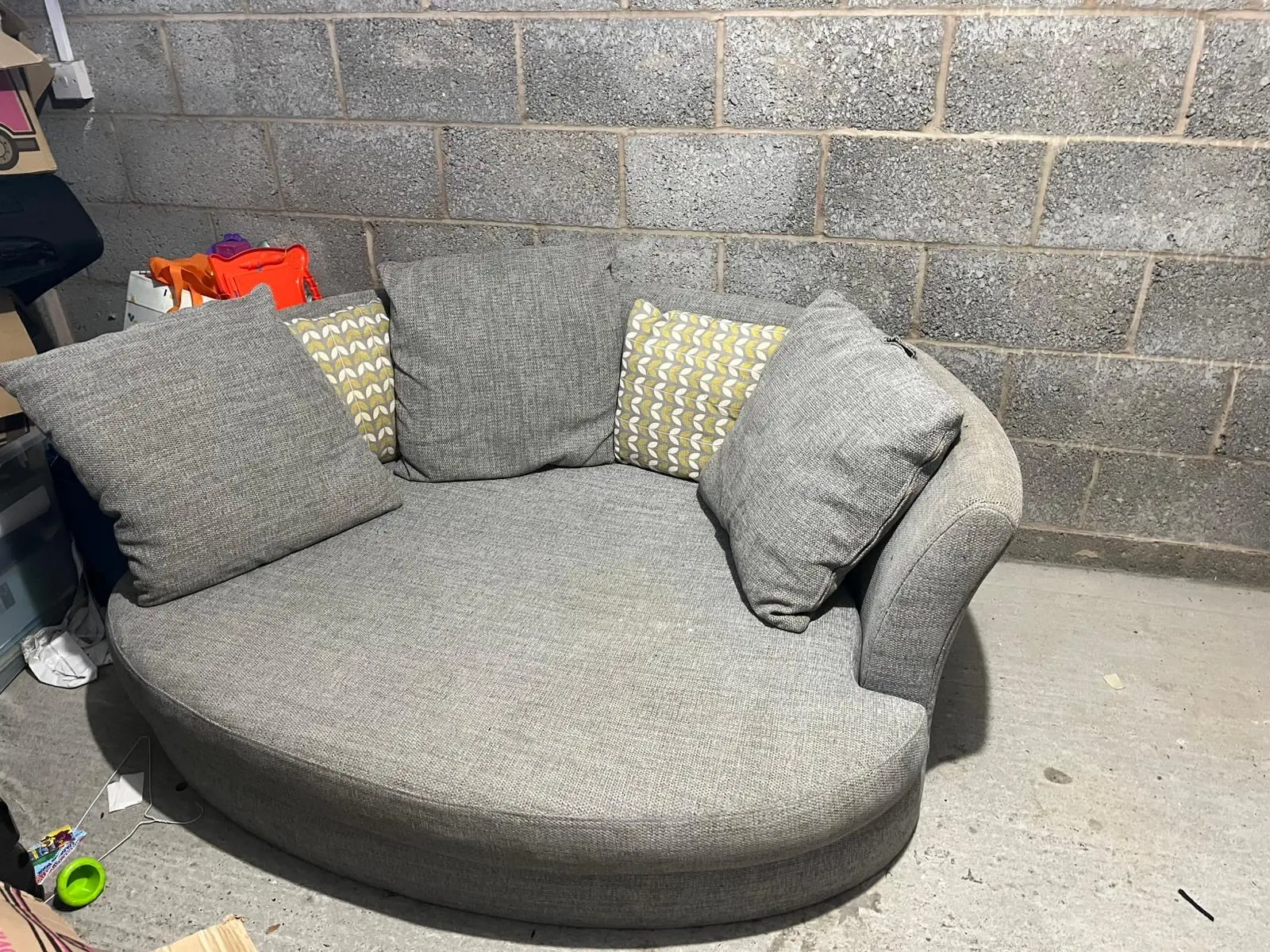 Grey DFS bay window -style sofa with thro pillows