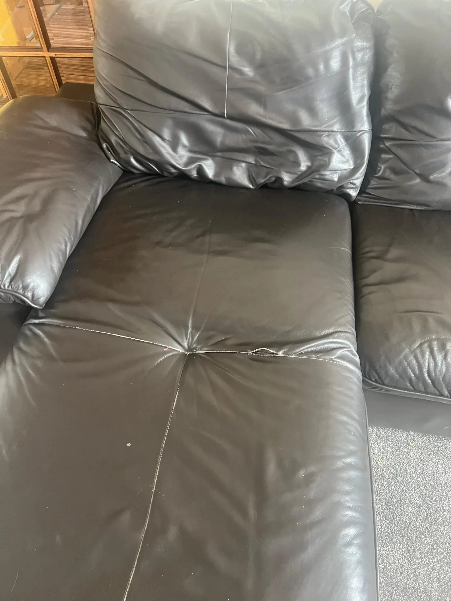 L-Shaped Black Leather Sofa – Minor Tear