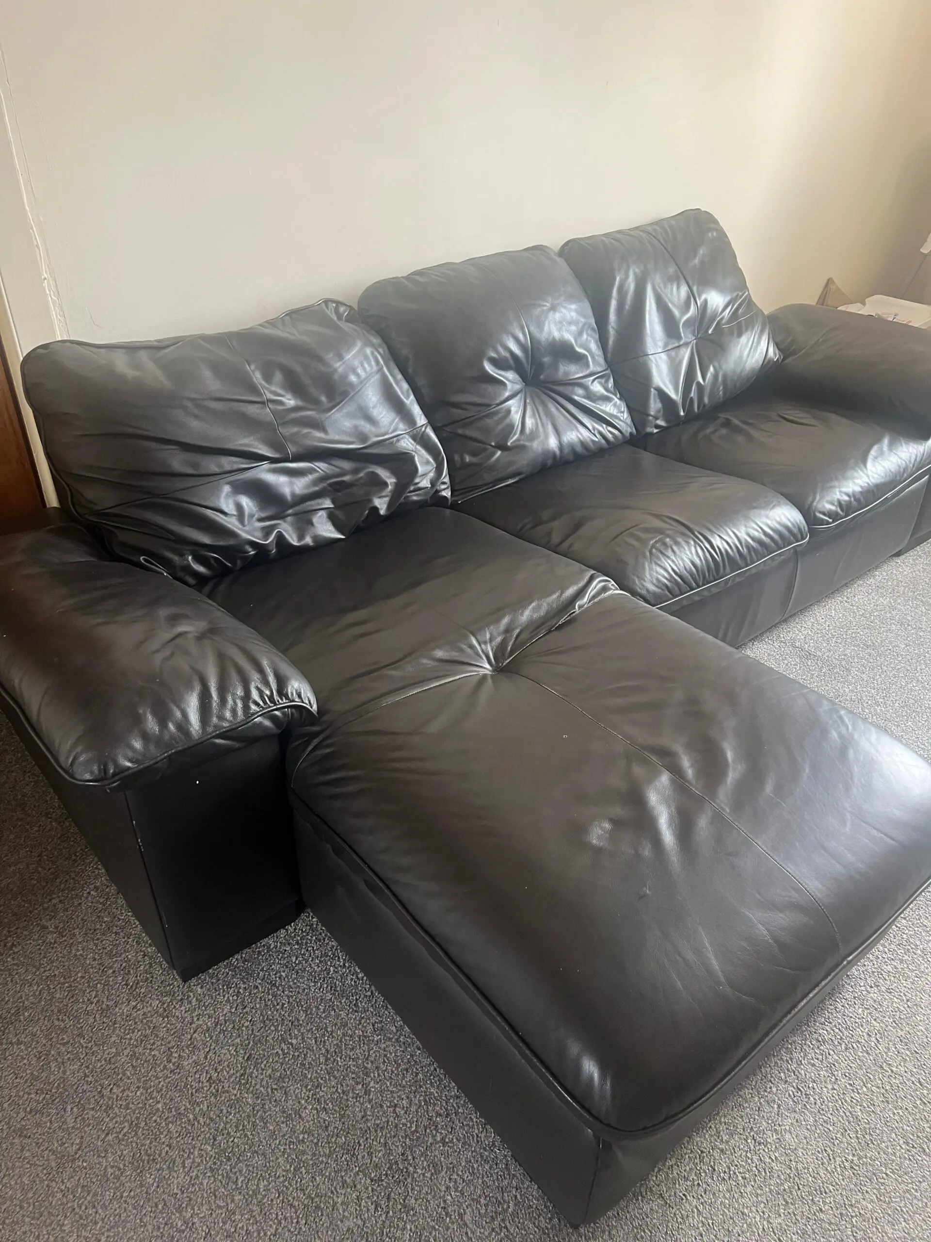 L-Shaped Black Leather Sofa – Minor Tear