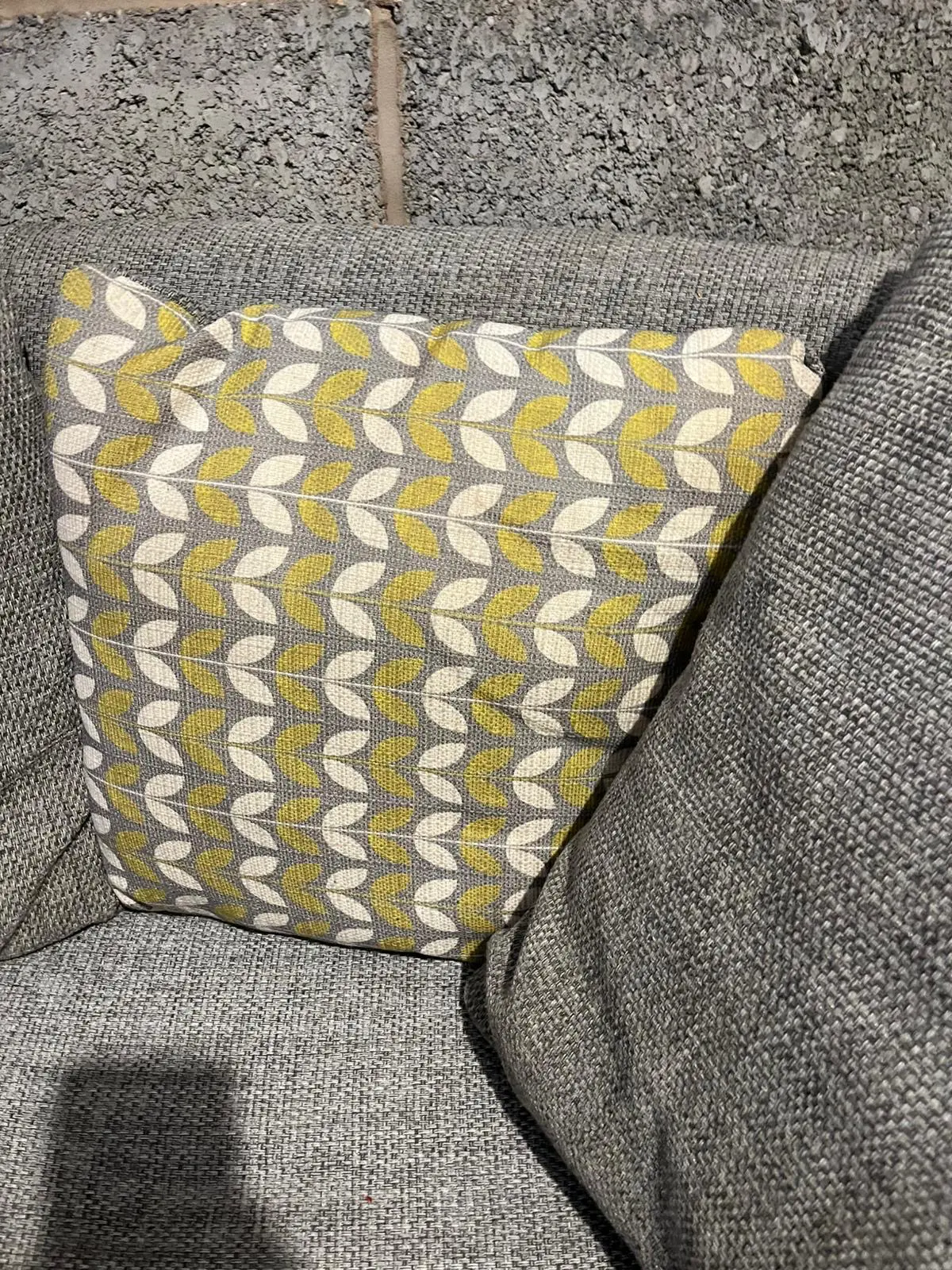 Grey DFS bay window -style sofa with thro pillows