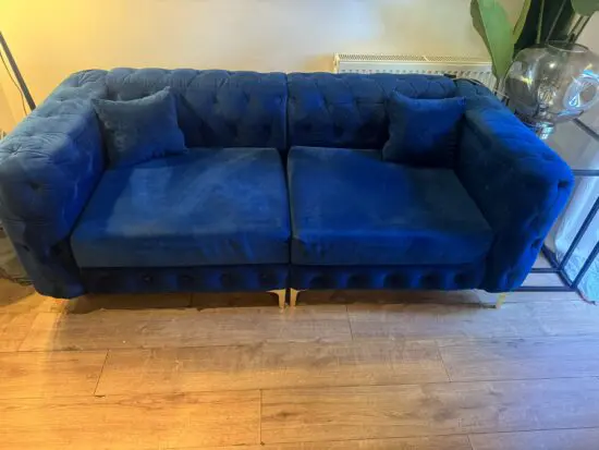 Beautiful blue velvet Chesterfield-style sofa.