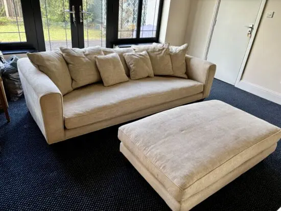 Two large Cream chenille John Sankey sofas with matching large footstool