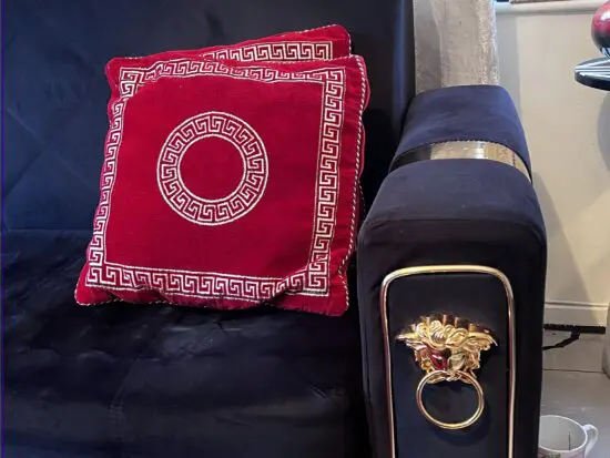 Three seater black and gold sofa come bed. Also with storage