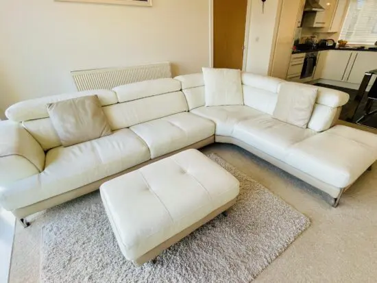 stunning white and beige corner sofa with chaise end, retractable head rests and foot stool by DFS