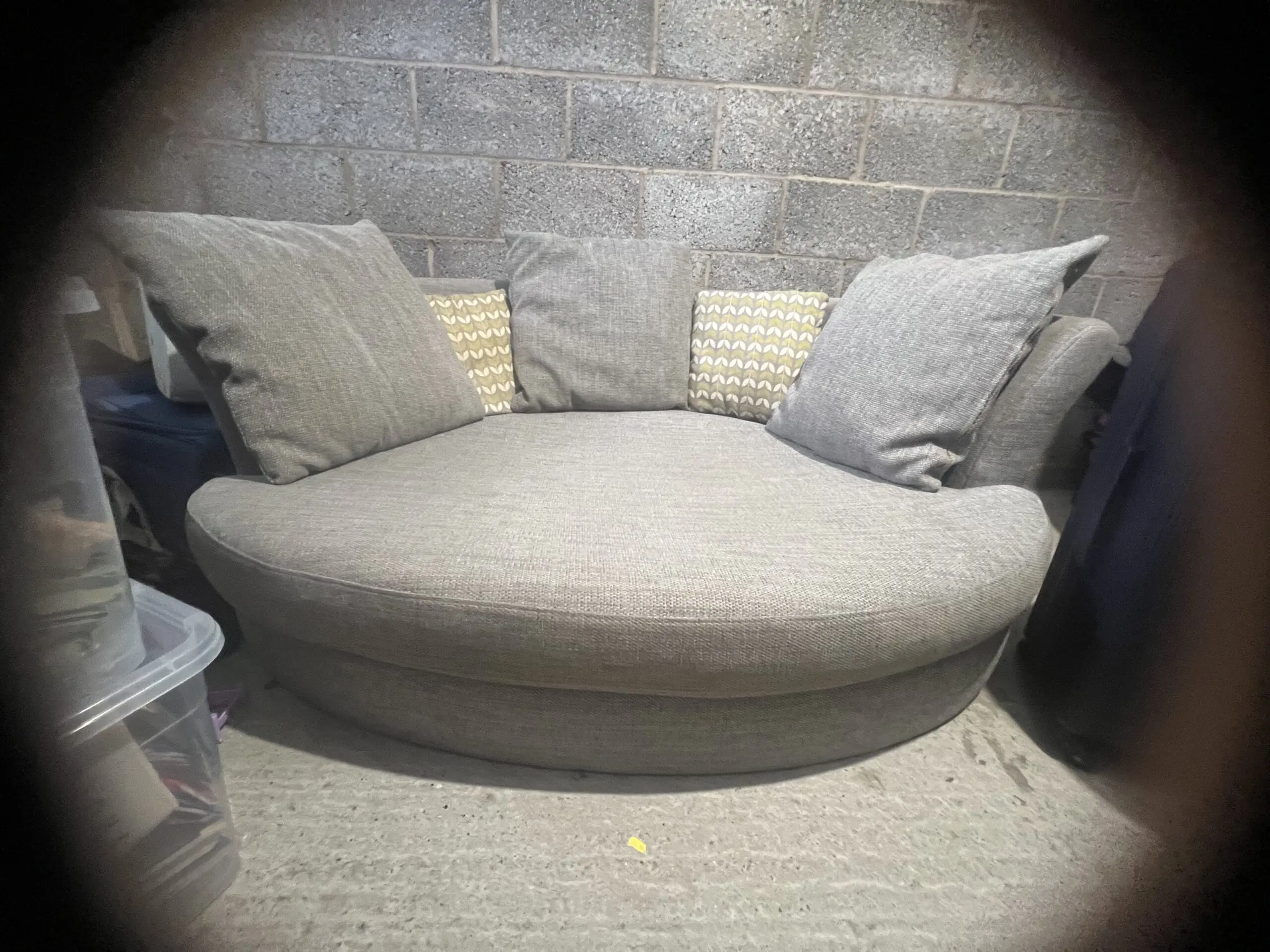 Grey DFS bay window -style sofa with thro pillows