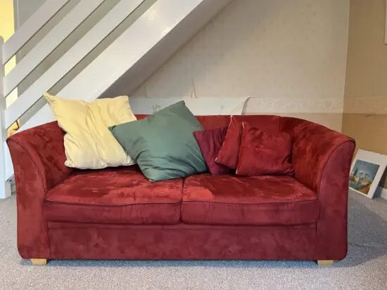 Red two seater sofa