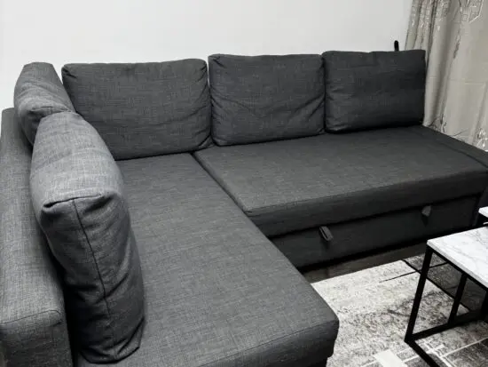 Corner L shape a grey sofa with storage