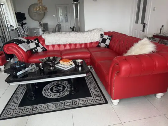 Large red chesterfield corner sofa