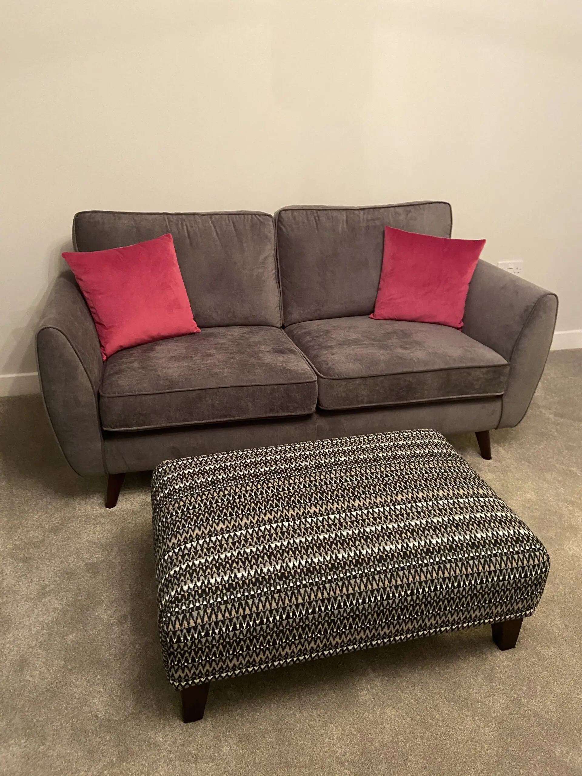 2 DFS charcoal grey Kyra 3-seater sofas with complementary footstool