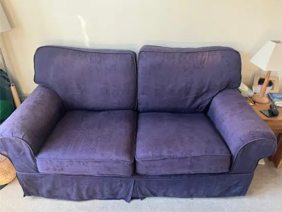 Two navy large two seater sofas