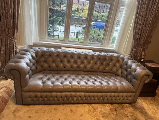 3 seater grey leather Chesterfield sofa and footstool